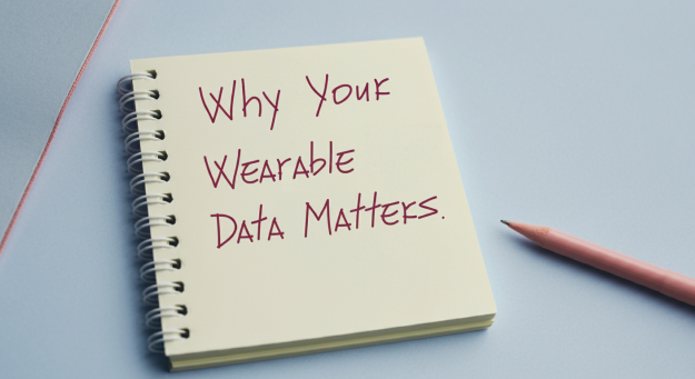 A notebook with "Why Your Wearable Data Matters" written on it, next to a pink pencil, emphasizing the importance of understanding wearable data privacy.